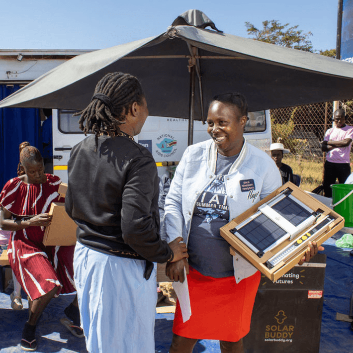 Giving a solar light to a nurse