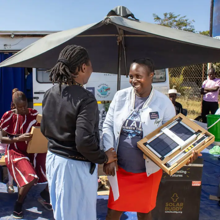 Giving a solar light to a nurse