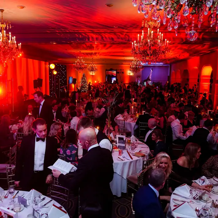 Corporate gala dinner and awards night in Dublin with elegant ballroom setup, chandeliers, and full guest tables.