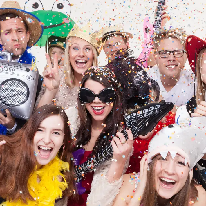 group posing with props at disco bingo music themed team building for corporates