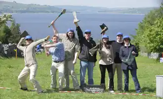 Corporate team outdoors celebrating after Irish-themed team building games