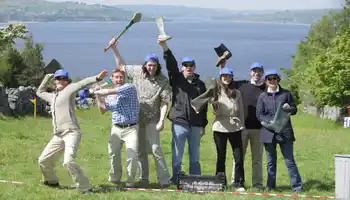 Corporate team outdoors celebrating after Irish-themed team building games