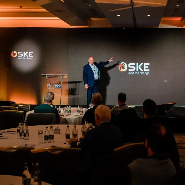 Speaker presenting on stage at company away day conference