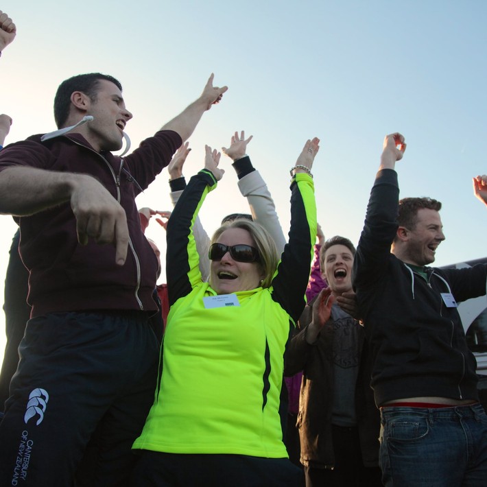 people celebrating doing an outdoor team building activity in ireland