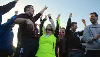 people celebrating doing an outdoor team building activity in ireland
