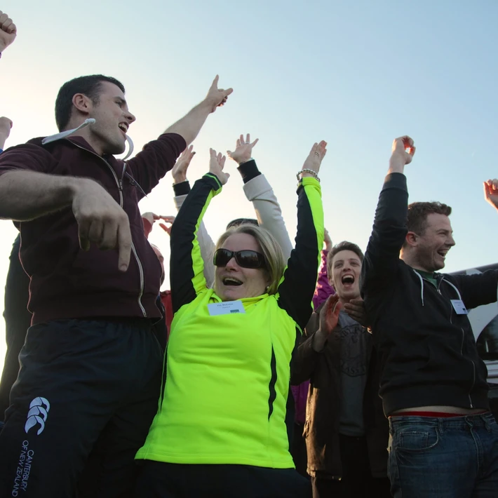 people celebrating doing an outdoor team building activity in ireland