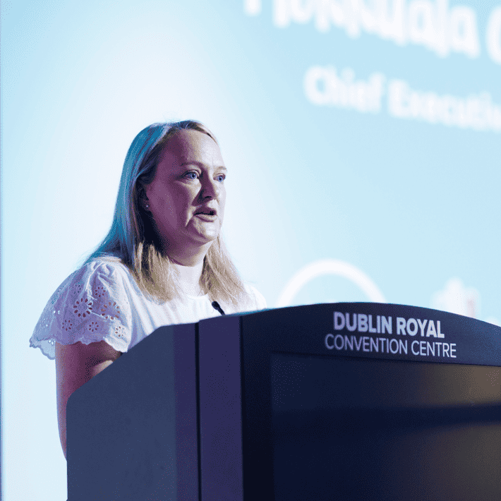 CHF MD presenting to the corproate participants about why they are there on top of a stage