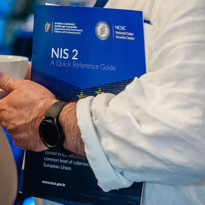 man holding booklet at conference