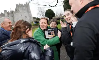 Corporate team enjoying a Venue Adventure digital treasure hunt on hotel grounds in Ireland, using an iPad to complete GPS challenges