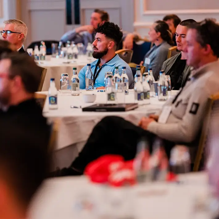 Attendees listening to keynote presentation at company away day meeting