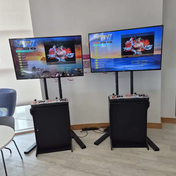 Retro arcade machines with two-player joystick controls at a corporate event in Dublin