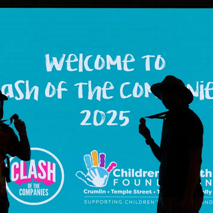 People posing infront of COTC signage