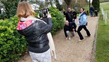 Corporate team using a tablet outdoors during a digital treasure hunt activity in Ireland