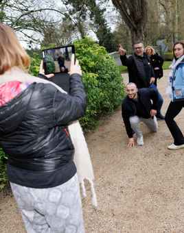 Corporate team using a tablet outdoors during a digital treasure hunt activity in Ireland