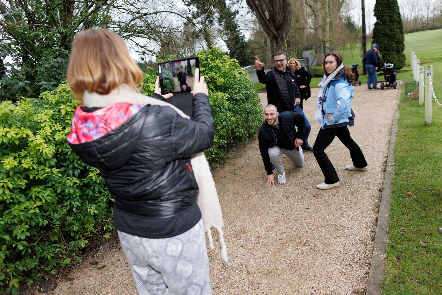 Corporate team using a tablet outdoors during a digital treasure hunt activity in Ireland