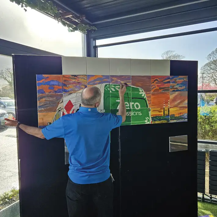 Dynamic Events facilitator assembling custom Big Picture artwork for DPD Ireland team building event in Galway