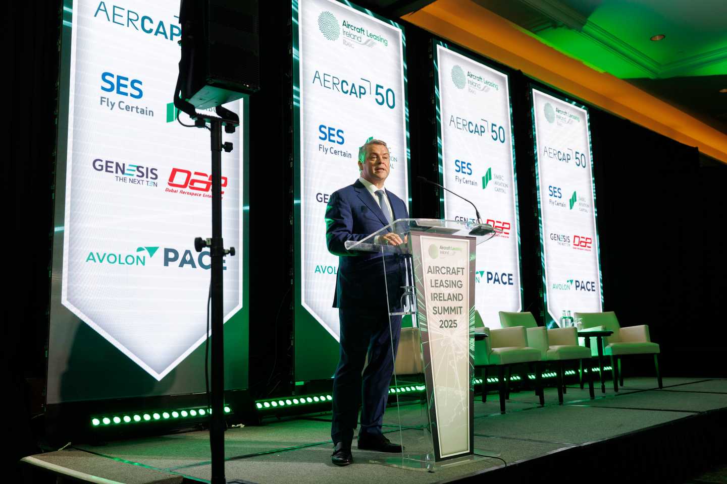 Man on a stage talking at the ALI 2025 Summit