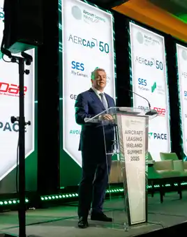 Man on a stage talking at the ALI 2025 Summit