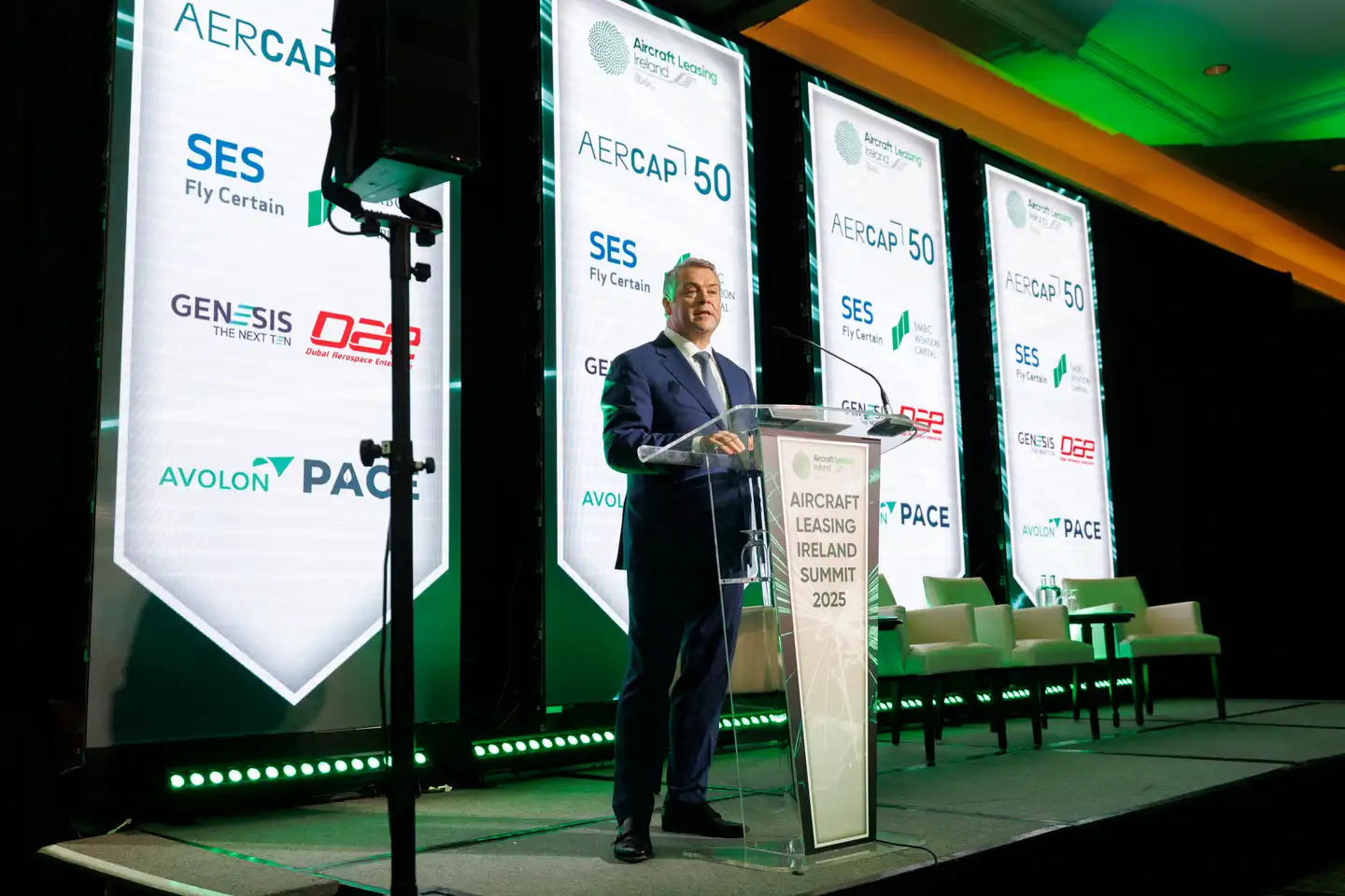 Man on a stage talking at the ALI 2025 Summit