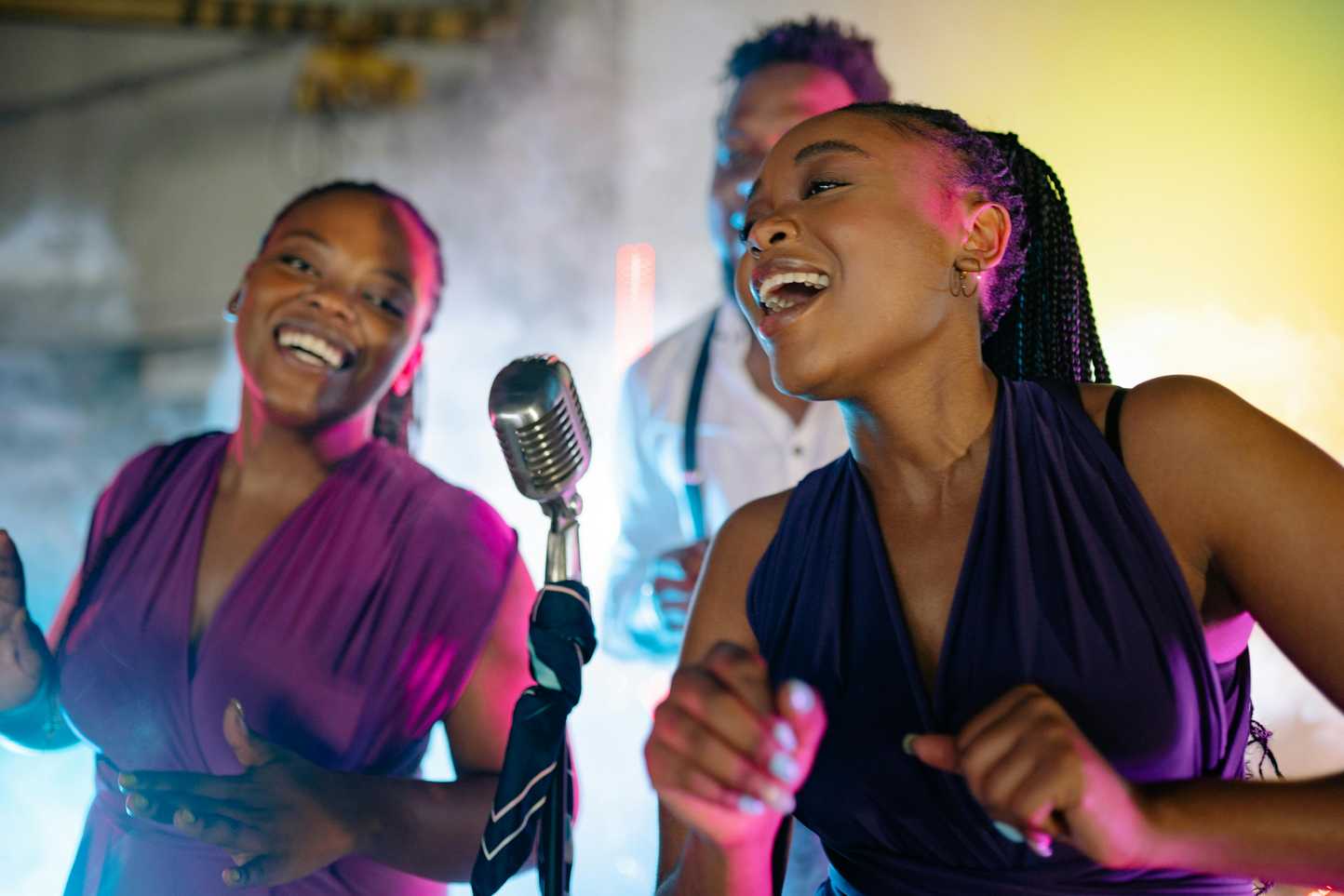 Team singing together on stage during corporate karaoke night in Ireland