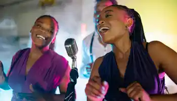 Team singing together on stage during corporate karaoke night in Ireland