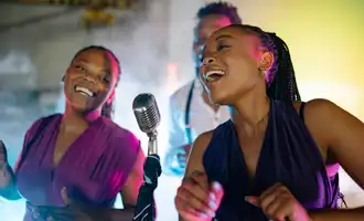 Team singing together on stage during corporate karaoke night in Ireland