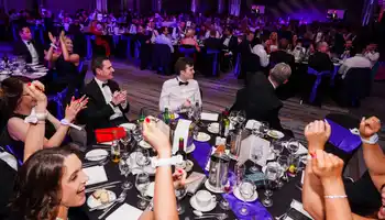 Corporate gala dinner and awards night in Dublin with 300 guests celebrating, cheering, and enjoying a formal black tie evening