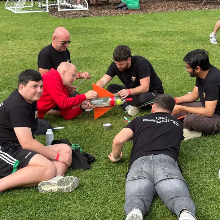 Hilti Ireland employees building a rocket during Rocket Challenge team building activity at corporate summer party