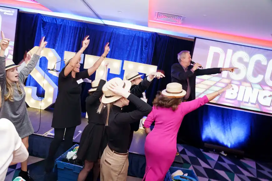 Corporate team building in Laois with Dynamic Events, employees enjoying a lively Disco Bingo game hosted on stage.