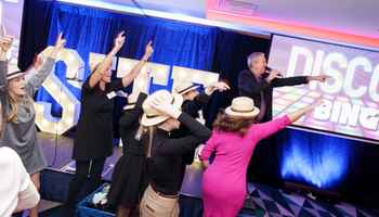 Christmas team building event with colleagues playing Disco Bingo and having fun