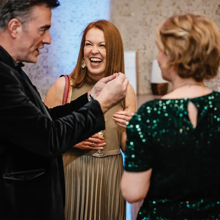 Interactive team building activity with magician engaging corporate group during a fun indoor workshop