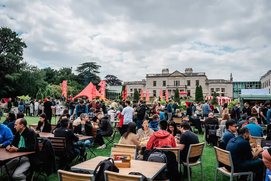 Corporate team building event in Carlow with employees socialising and enjoying food outdoors