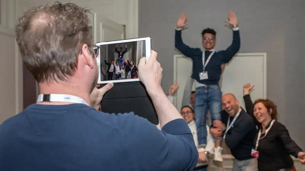 Corporate team building activity indoors in Belfast with colleagues working together.