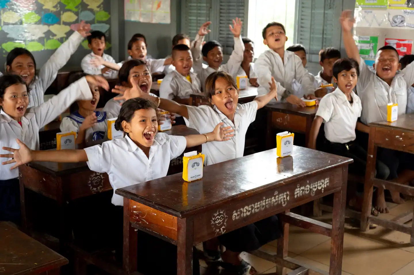 Children celebrating after receiving SolarBuddy lights in Cambodia