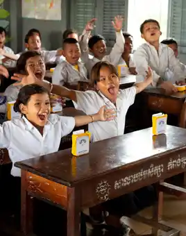 Children celebrating after receiving SolarBuddy lights in Cambodia