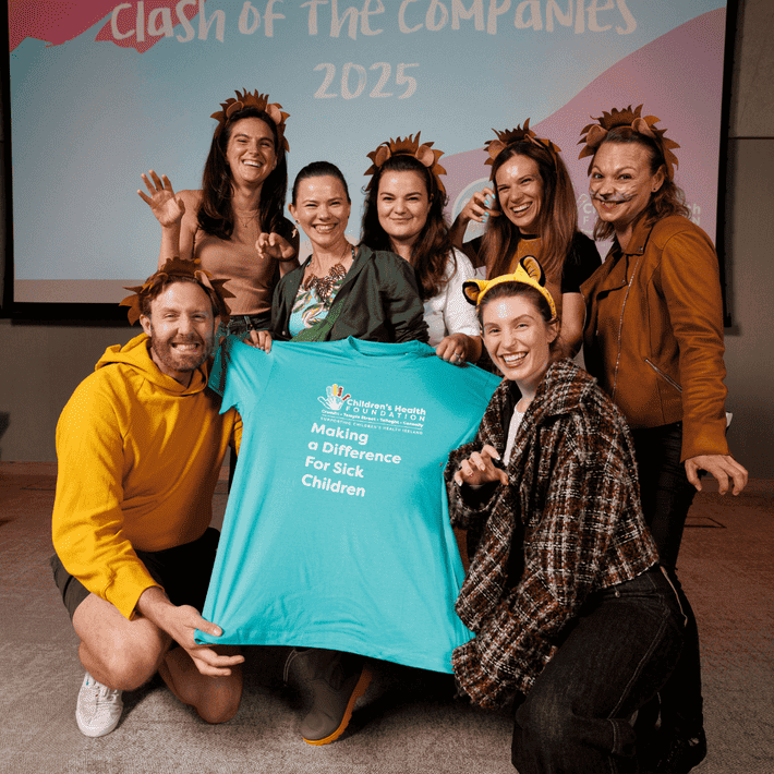 Team Dressed up in jungle themed costumes posing for a picture with the childrens health foundations branded shirts