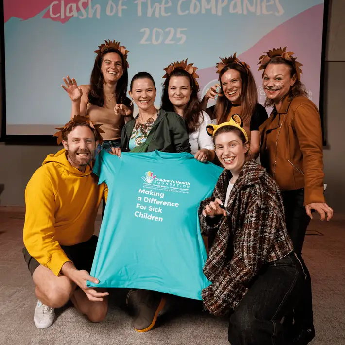 Team Dressed up in jungle themed costumes posing for a picture with the childrens health foundations branded shirts