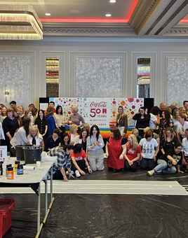 Coca-Cola team taking part in a Big Picture team building painting activity at Johnstown Estate to celebrate 50 years in Drogheda with Dynamic Events Ireland.