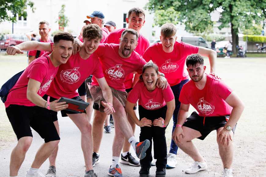 Corporate team building in Laois, group of employees in matching pink shirts posing outdoors during a treasure hunt challenge.