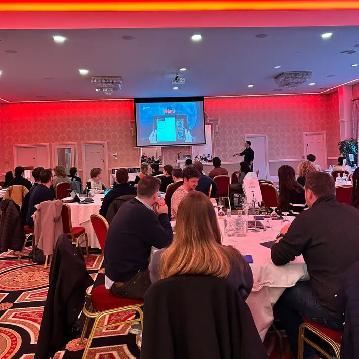 Corporate team solving the Manor House Murder challenge during an indoor team building event.