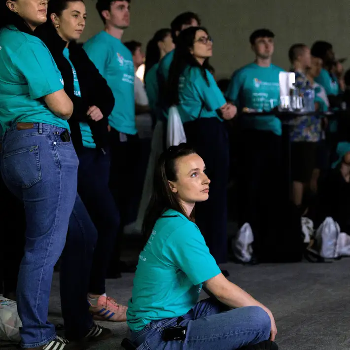 Corporate participants receiving their challenge briefing before the Jungle Survival game