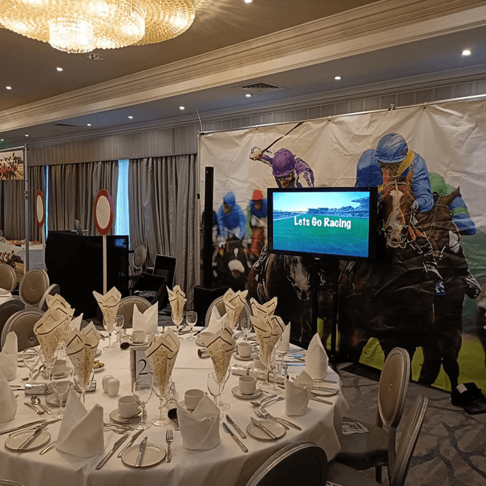 Indoor event setup with Race Night props and race screens