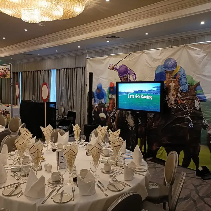 Indoor event setup with Race Night props and race screens