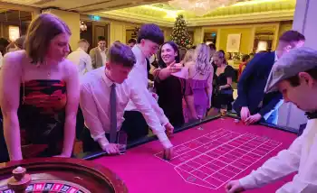 Guests enjoying a corporate Christmas casino night with roulette and festive decorations in Ireland.