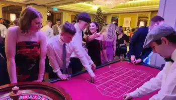 Guests enjoying a corporate Christmas casino night with roulette and festive decorations in Ireland.