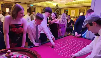 Guests enjoying a corporate Christmas casino night with roulette and festive decorations in Ireland.