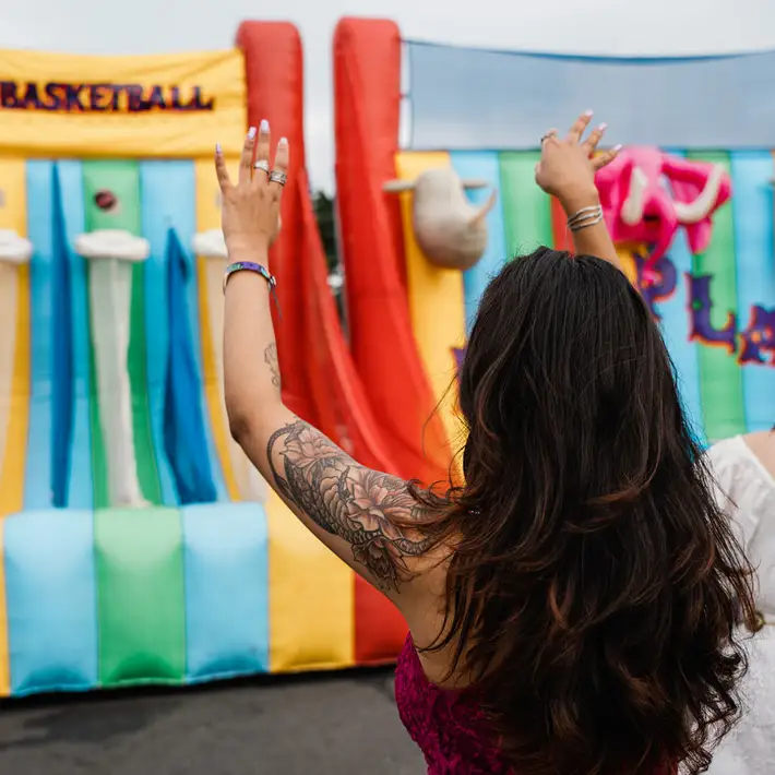 Team taking part in the inflatable basketball at outdoor staff appreciation day