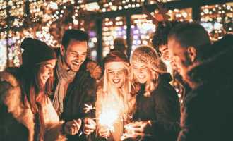 people lighting sparklers at Christmas