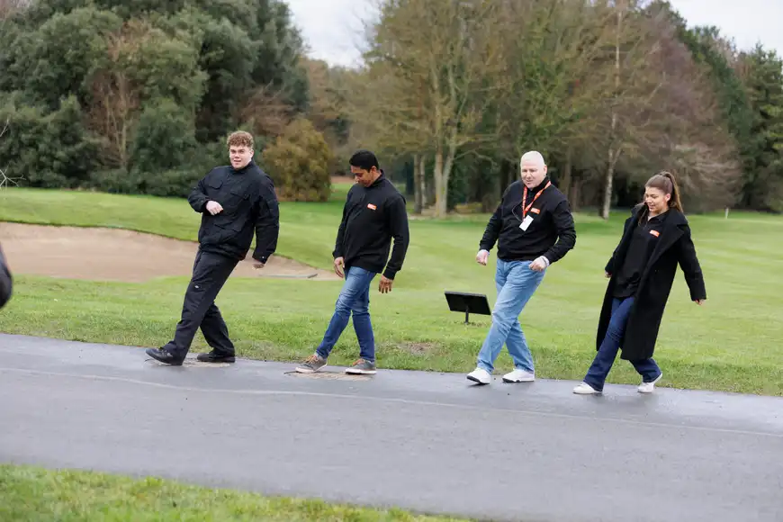 Executives participating in outdoor leadership team building activity in Ireland