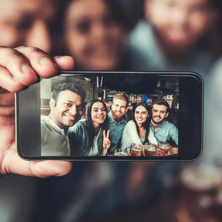 Remote team building pub safari with colleagues taking group selfie